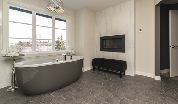 Modern bathroom with pale green tiles, large shower and bathtub.